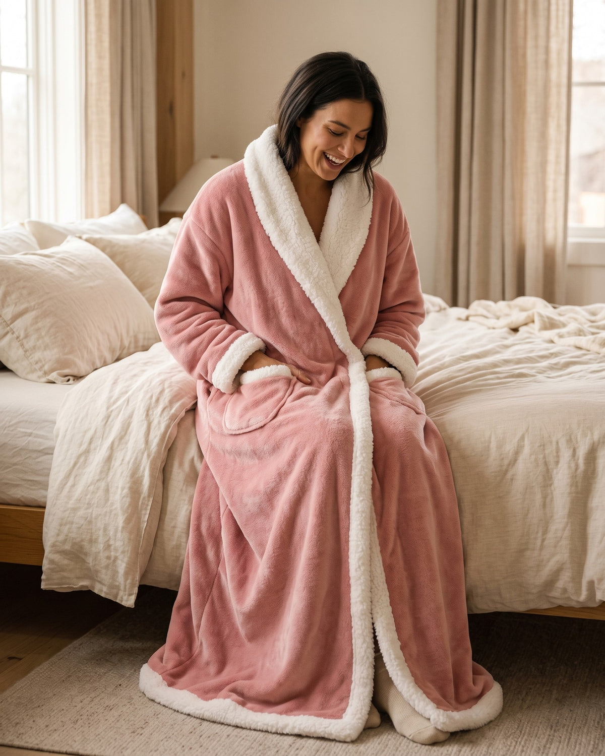 Pink Hugwarm blanket open at the front showing the white sherpa lining and hand pockets